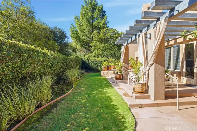 an aerial view of a house with garden space and deck