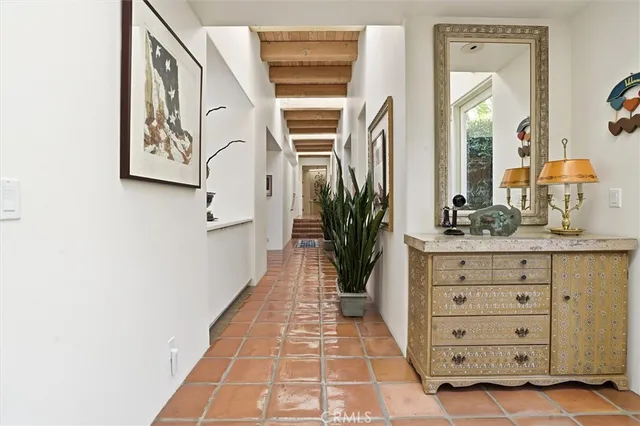 a view of a dining room with furniture one side kitchen view and a window