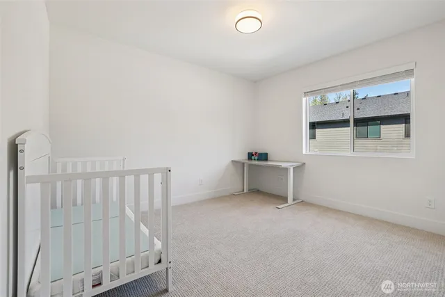 a spacious bedroom with a bed and a window