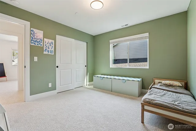 a bathroom with a granite countertop sink mirror and toilet