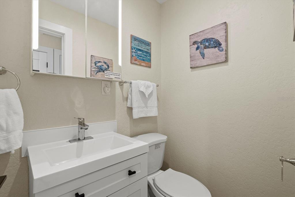 5830 Midnight Pass Road, Unit 63 Sarasota, FL 34242 - Photo 11 of 27 a bathroom with a sink mirror and toilet
