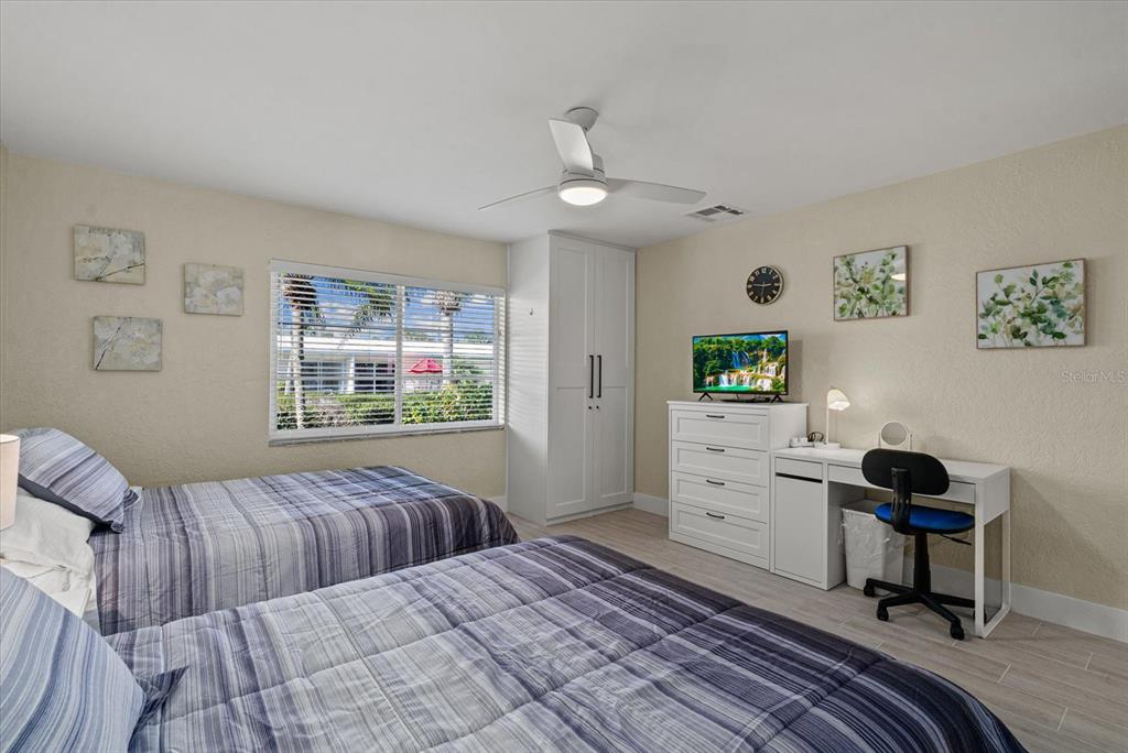 5830 Midnight Pass Road, Unit 63 Sarasota, FL 34242 - Photo 13 of 27 a bedroom with a bed and a table in it