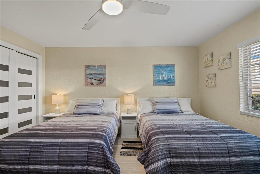 5830 Midnight Pass Road, Unit 63 Sarasota, FL 34242 - Photo 14 of 27 a bedroom with two beds and a window