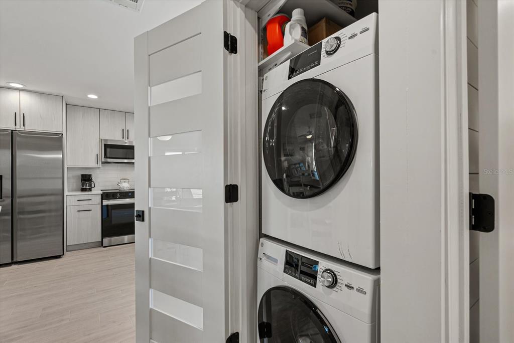 5830 Midnight Pass Road, Unit 63 Sarasota, FL 34242 - Photo 16 of 27 a view of kitchen with washer and dryer