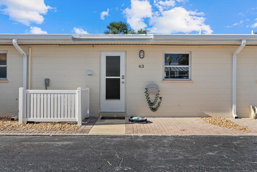 5830 Midnight Pass Road, Unit 63 Sarasota, FL 34242 - Photo 17 of 27 a view of a house with a backyard