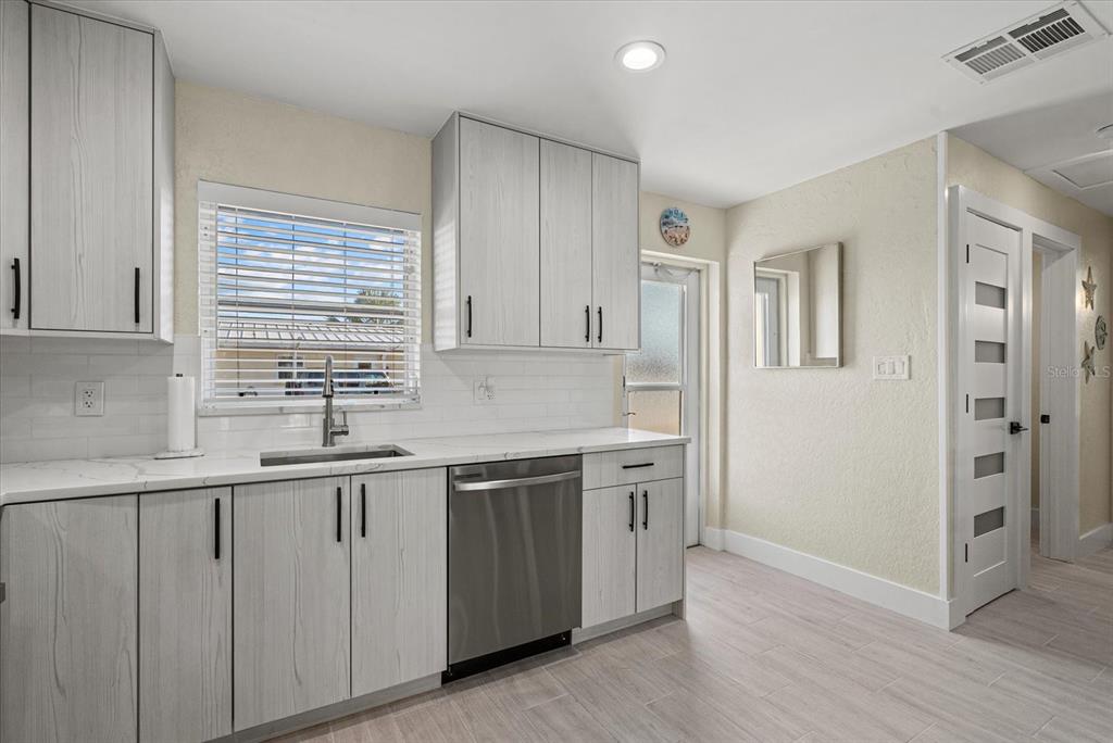 5830 Midnight Pass Road, Unit 63 Sarasota, FL 34242 - Photo 4 of 27 a kitchen with a sink and cabinets