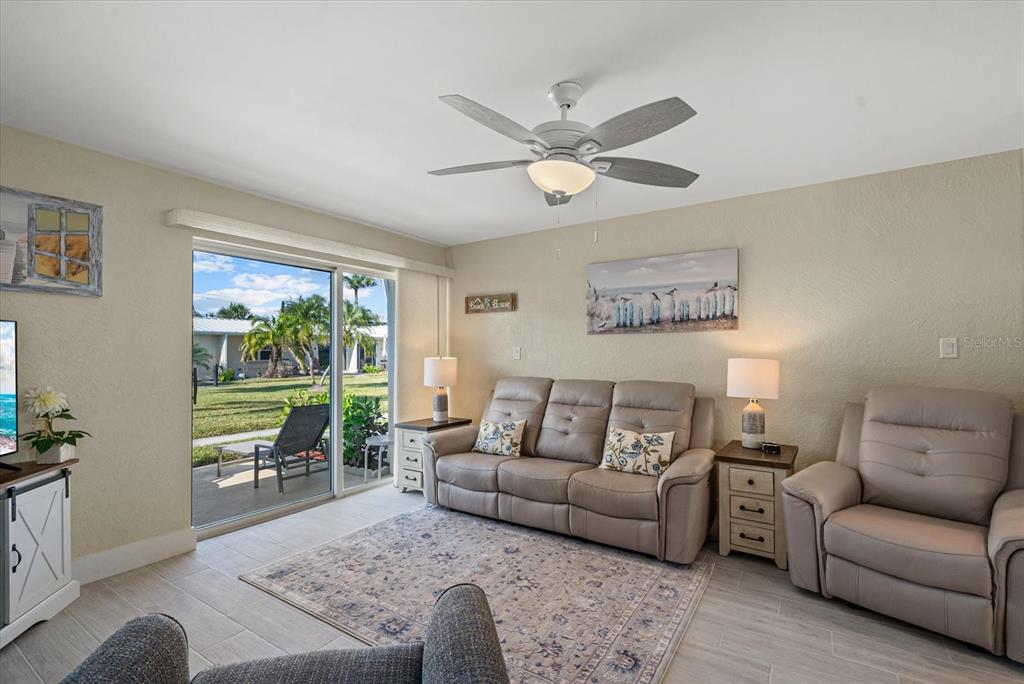 5830 Midnight Pass Road, Unit 63 Sarasota, FL 34242 - Photo 7 of 27 a living room with furniture and a large window