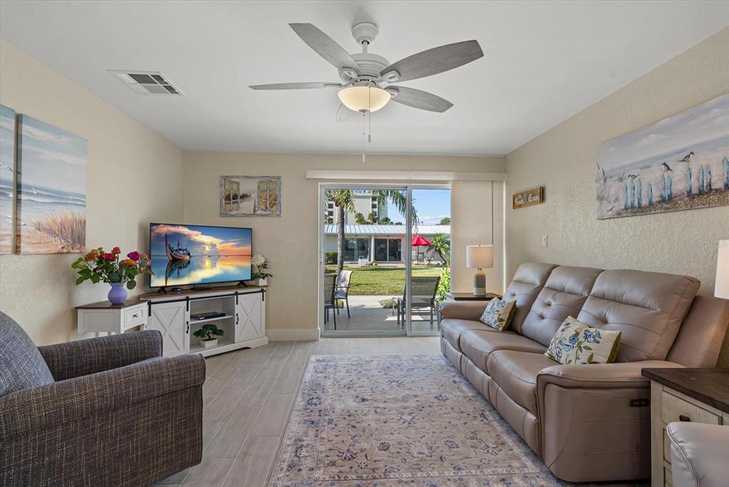 5830 Midnight Pass Road, Unit 63 Sarasota, FL 34242 - Photo 8 of 27 a living room with furniture and a flat screen tv