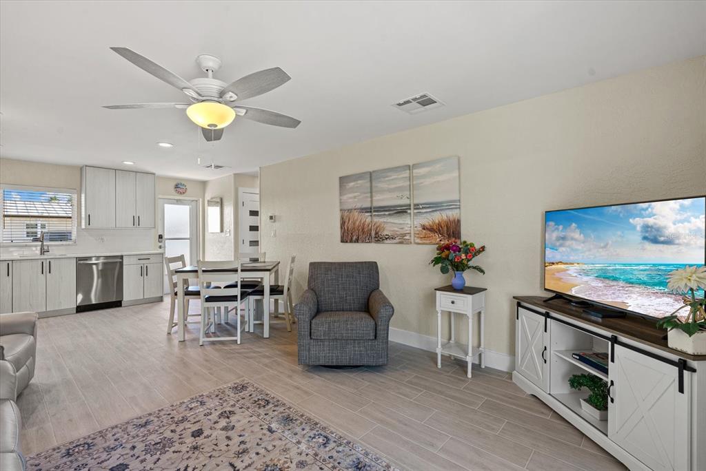 5830 Midnight Pass Road, Unit 63 Sarasota, FL 34242 - Photo 10 of 27 a living room with furniture and kitchen view