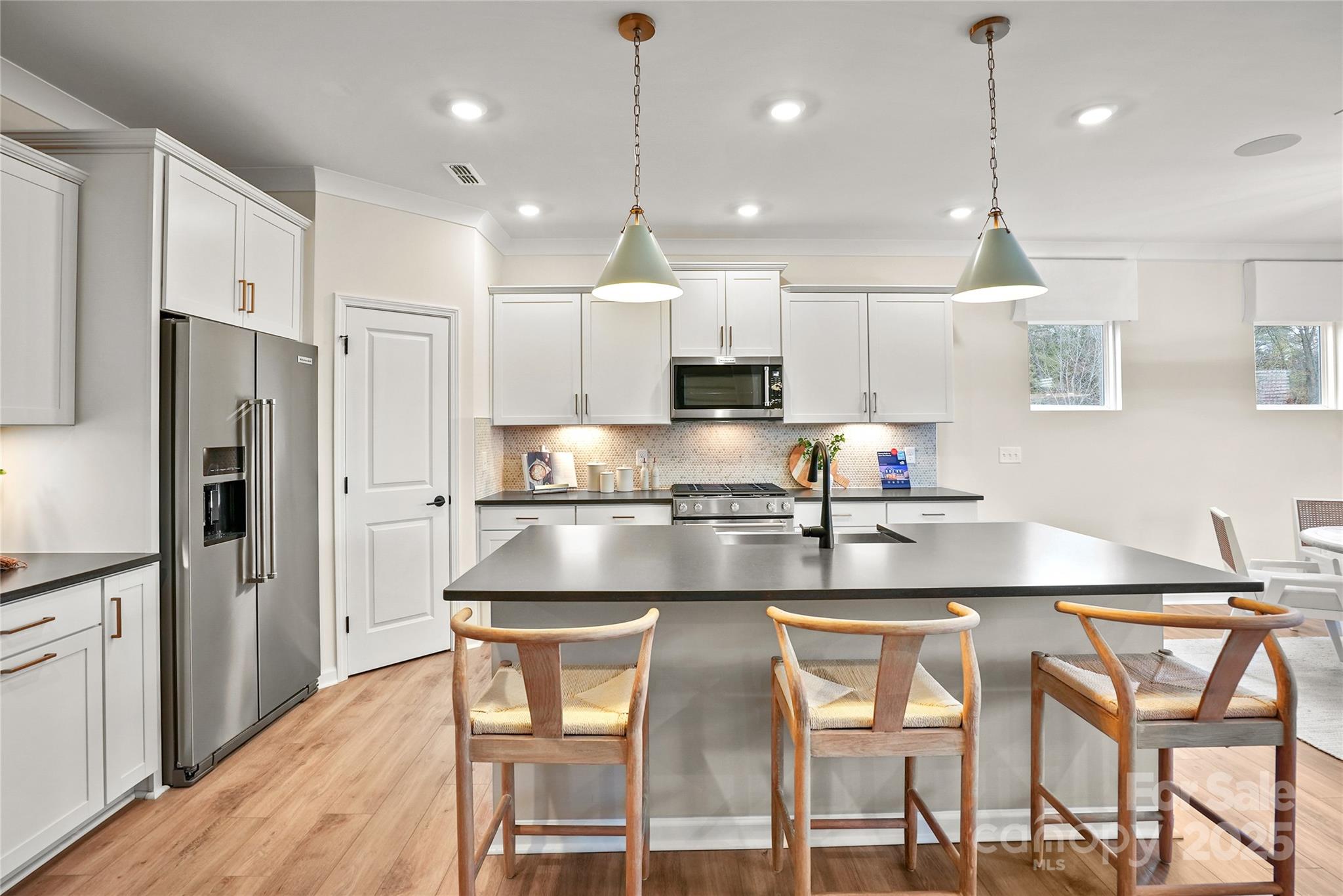 13736 Roderick Drive, Unit 171 Huntersville, NC 28078 - Photo 5 of 14 a kitchen with kitchen island granite countertop a counter space stainless steel appliances and cabinets