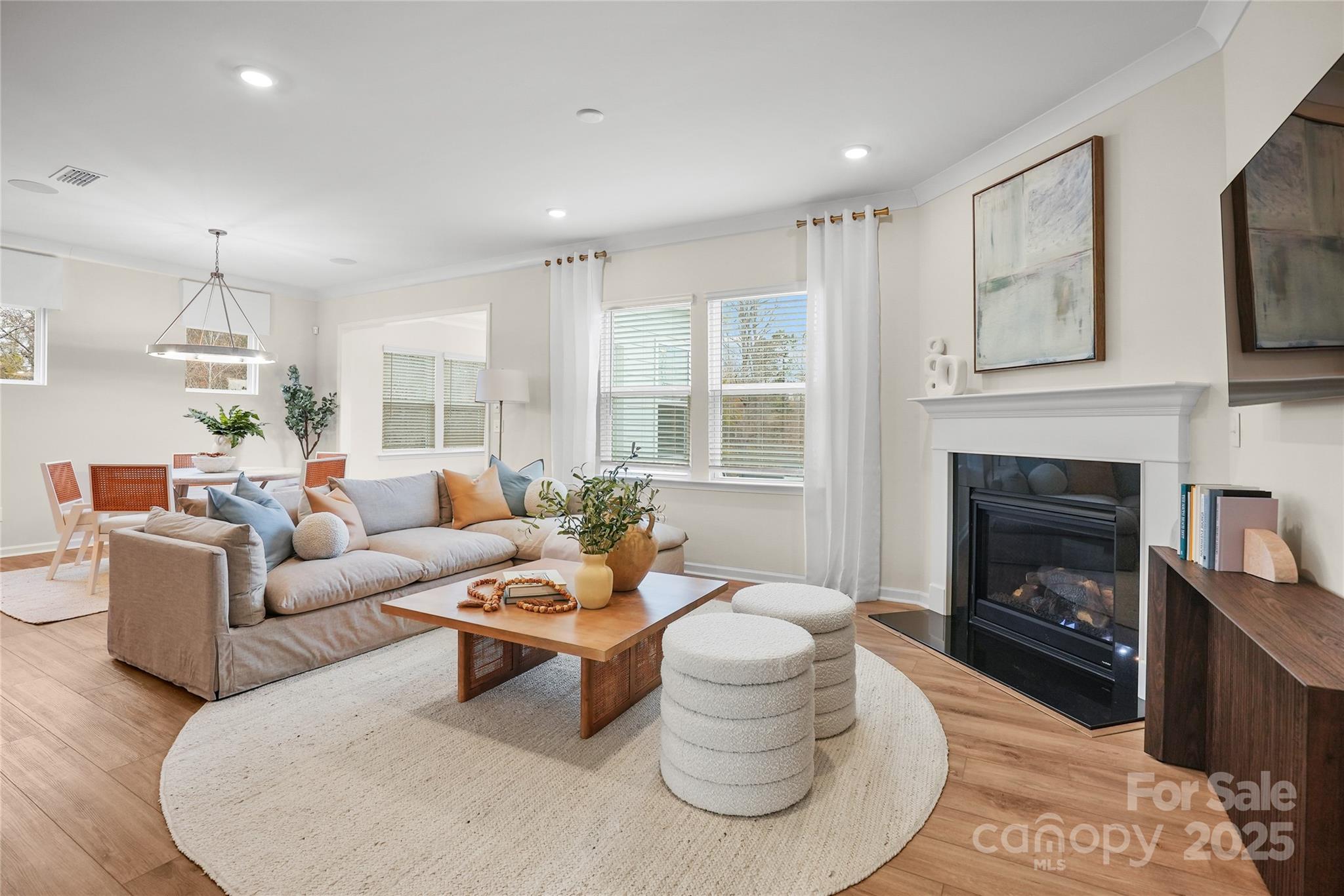 13736 Roderick Drive, Unit 171 Huntersville, NC 28078 - Photo 6 of 14 a living room with furniture a fireplace and a flat screen tv