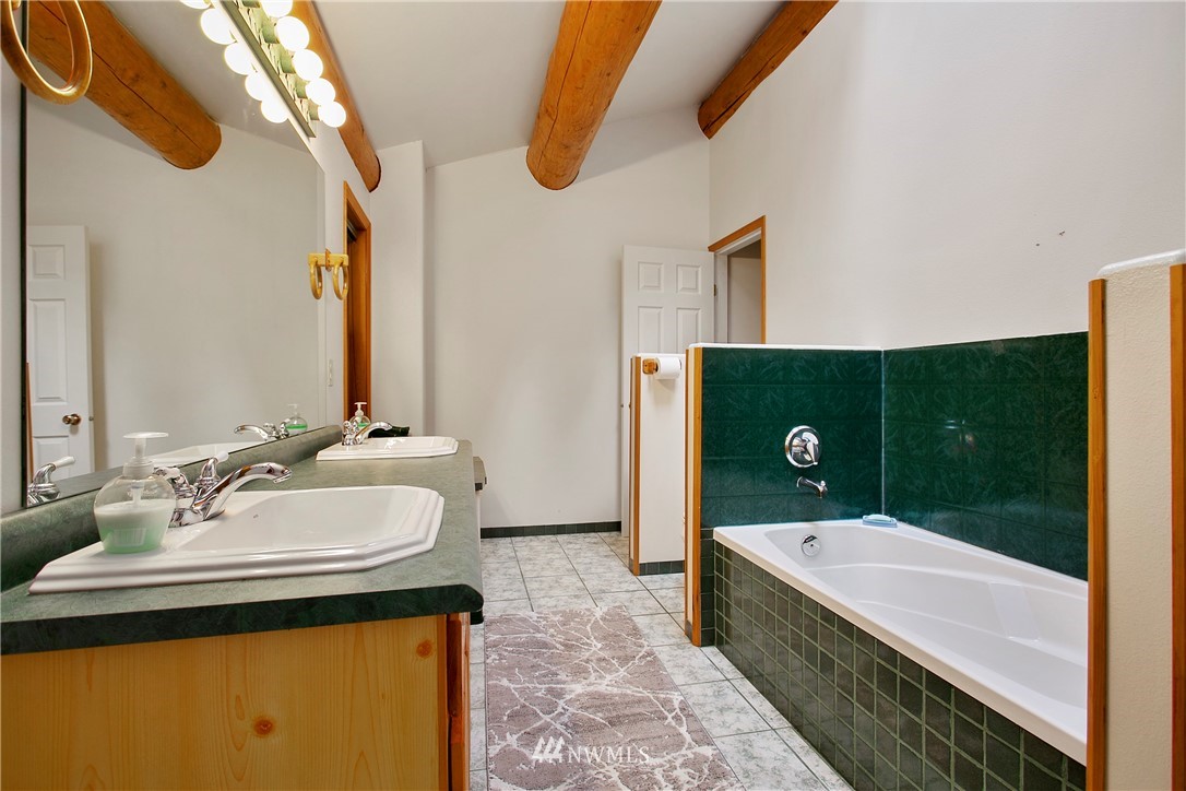 7097 Rainier Way Deming, WA 98244 - Photo 15 of 37 a bathroom with a sink and a mirror