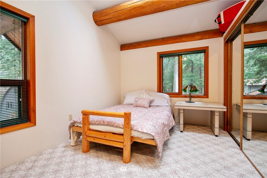 7097 Rainier Way Deming, WA 98244 - Photo 17 of 37 a bedroom with a bed and large windows