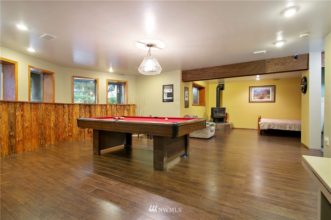 7097 Rainier Way Deming, WA 98244 - Photo 18 of 37 a living room with furniture pool table and a wooden floor