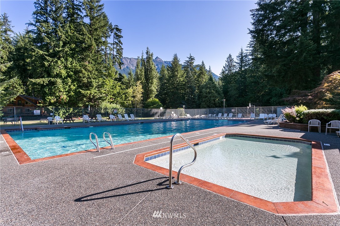 7097 Rainier Way Deming, WA 98244 - Photo 33 of 37 a swimming pool with outdoor seating and yard