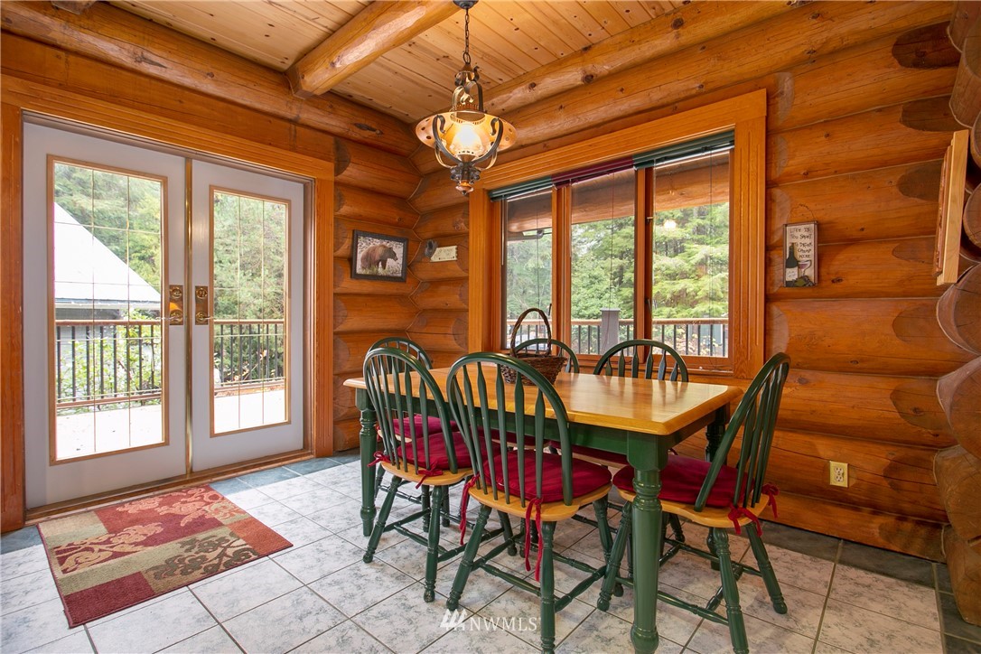 7097 Rainier Way Deming, WA 98244 - Photo 6 of 37 a dining room with furniture a chandelier and wooden floor