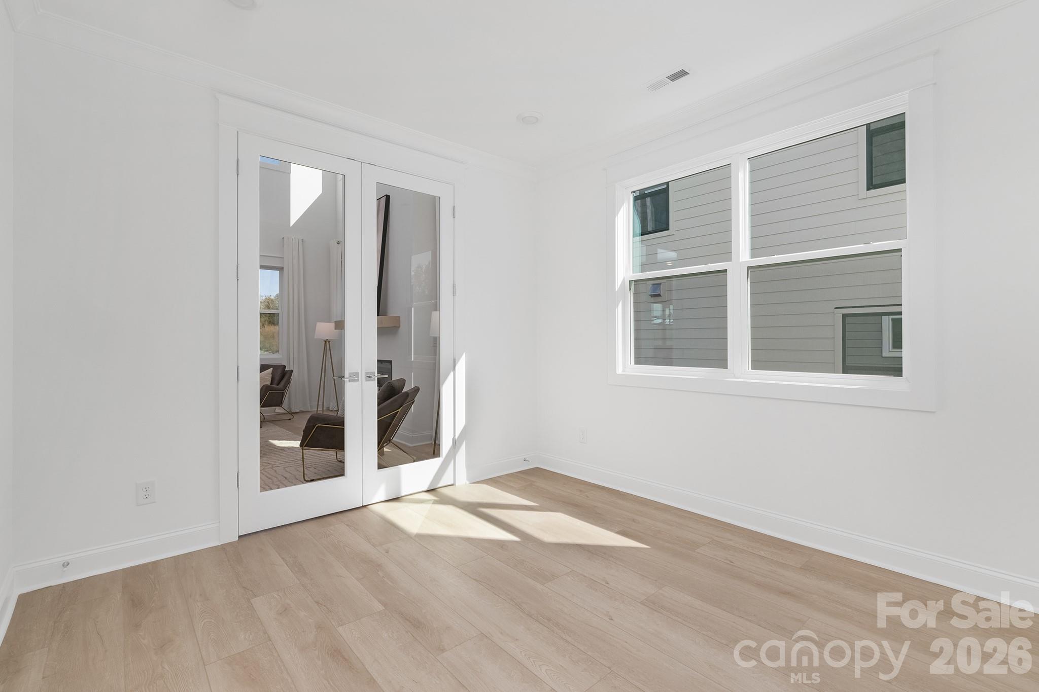 220 Windy Dell Drive Tega Cay, SC 29708 - Photo 9 of 13 a view of an empty room with wooden floor and a window