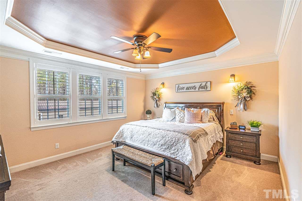 535 Barber Road Carthage, NC 28327 - Photo 12 of 30 a bedroom with a bed and a chandelier