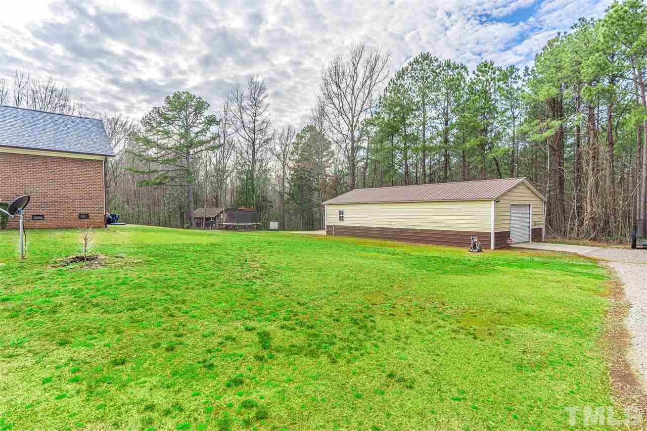 535 Barber Road Carthage, NC 28327 - Photo 14 of 30 a view of a backyard with a garden and trees