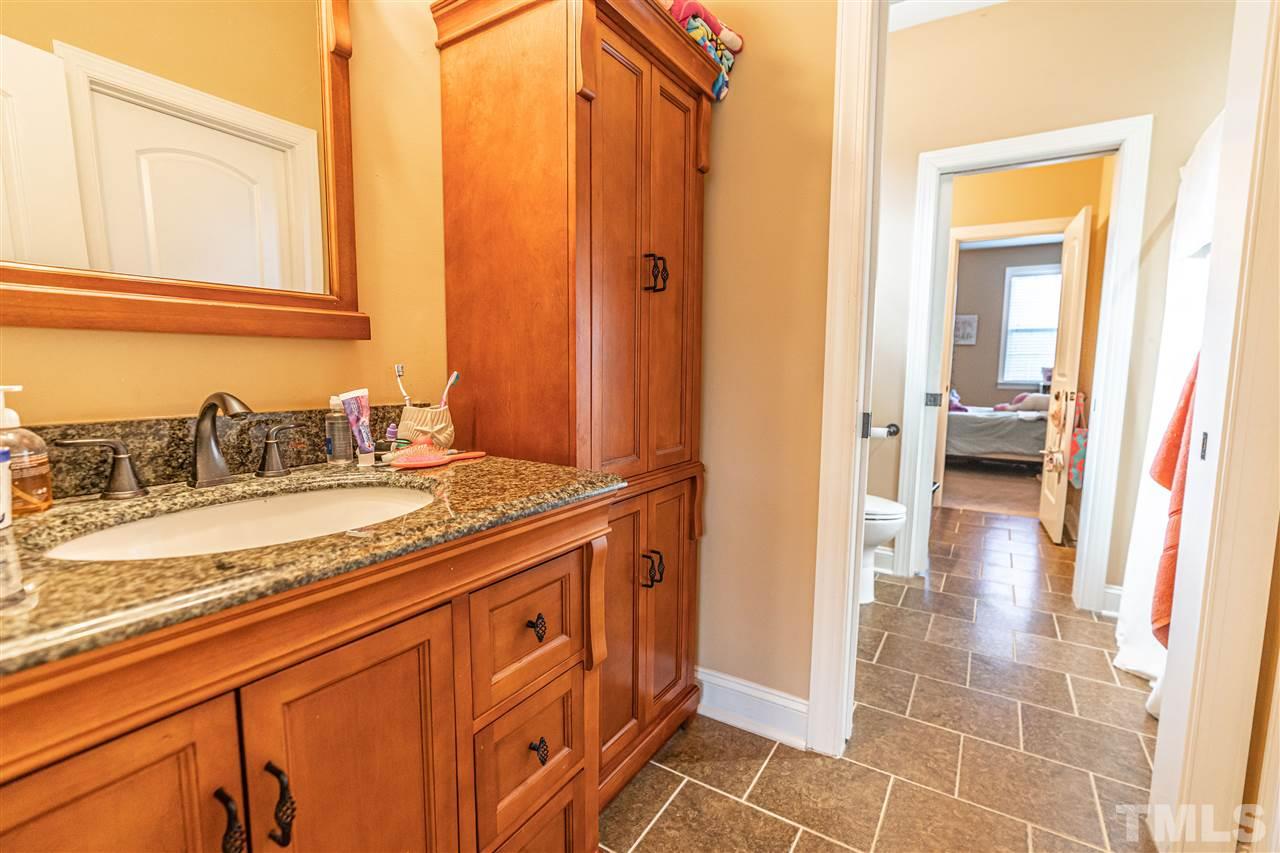 535 Barber Road Carthage, NC 28327 - Photo 21 of 30 a bathroom with a granite countertop sink a mirror and a shower