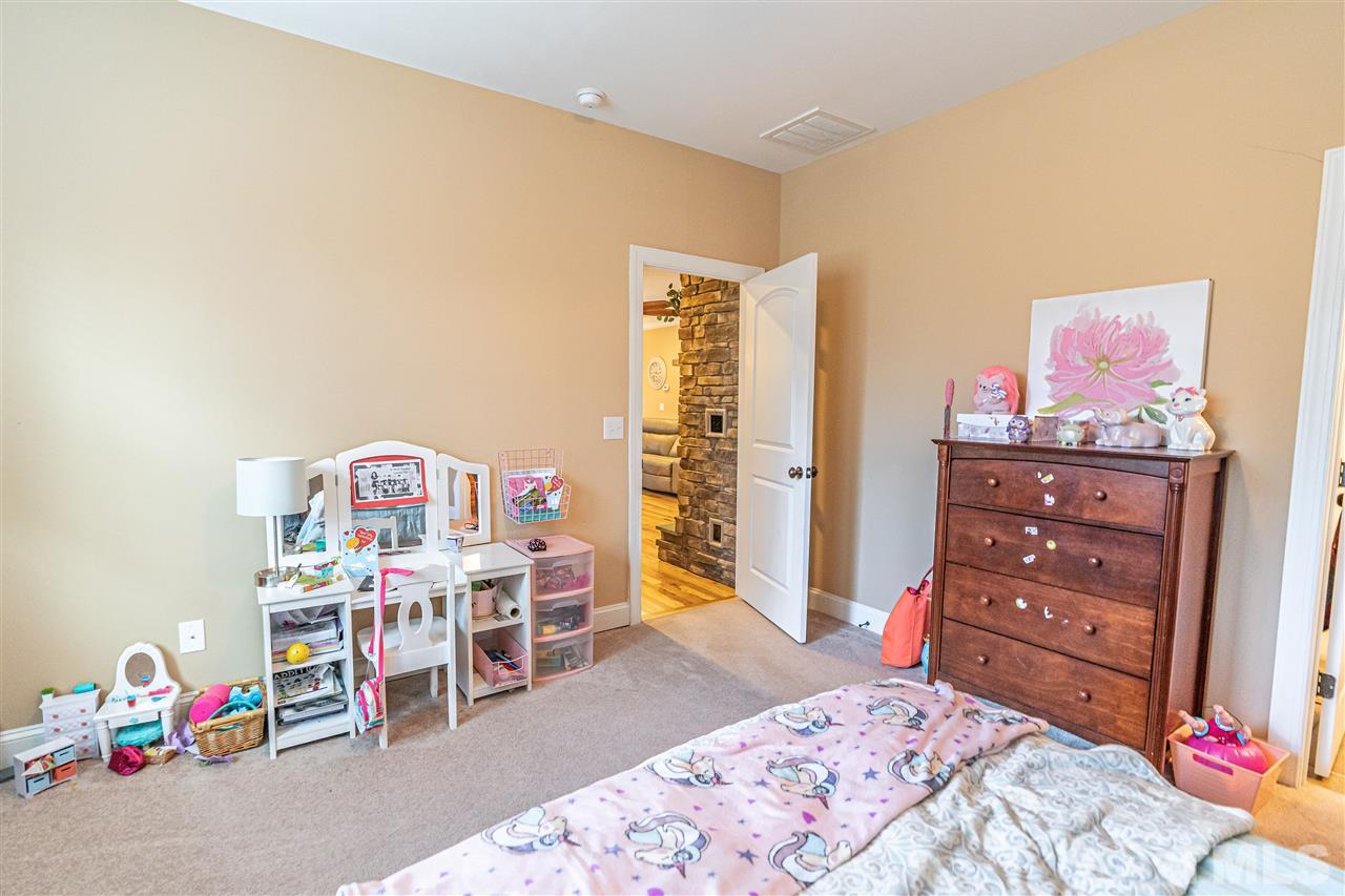 535 Barber Road Carthage, NC 28327 - Photo 22 of 30 a bedroom with a bed a desk and chair
