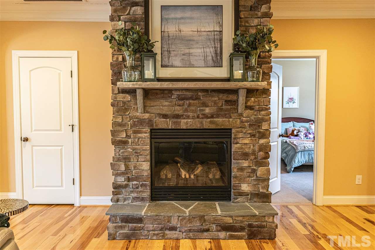535 Barber Road Carthage, NC 28327 - Photo 6 of 30 a living room with a fireplace and a wooden floor