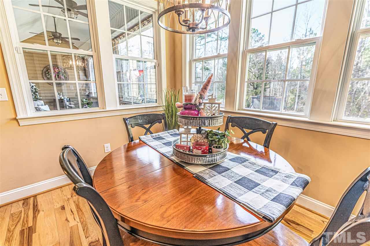 535 Barber Road Carthage, NC 28327 - Photo 10 of 30 a view of a dining room with furniture a chandelier and wooden floor