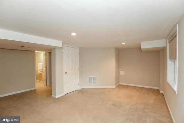 an empty room with windows and closet