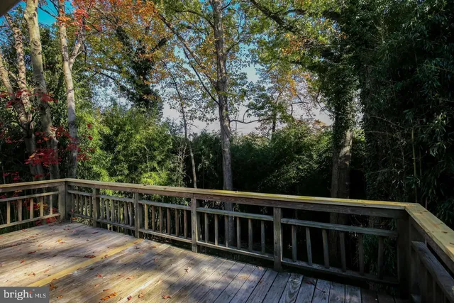 a view of balcony with deck and trees