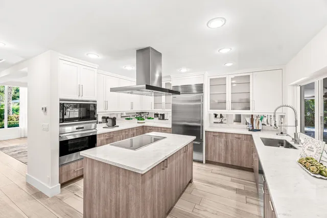 a kitchen with a sink stove top oven and refrigerator