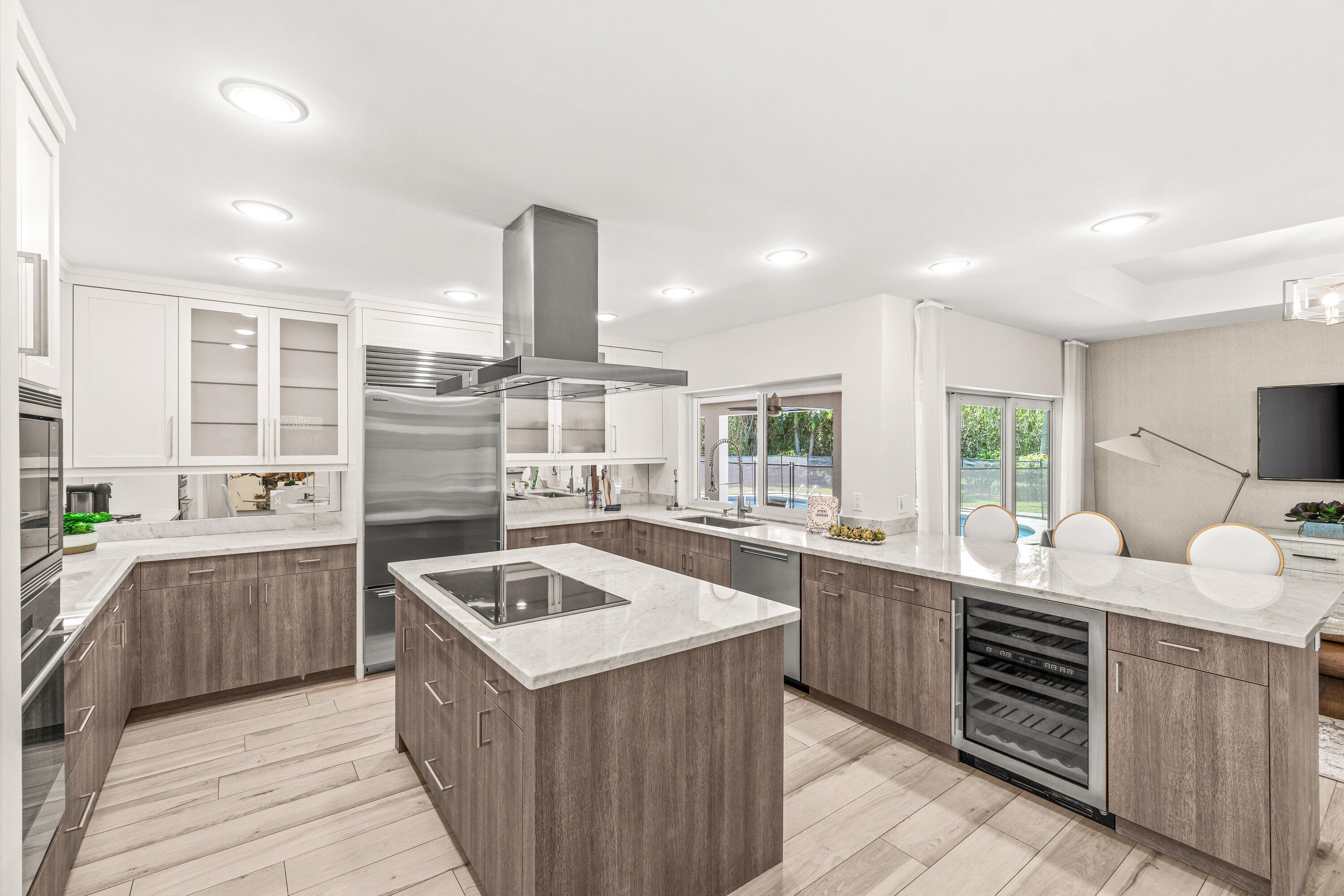 2367 Queen Palm Road Boca Raton, FL 33432 - Photo 12 of 45 a kitchen with a sink stove and cabinets