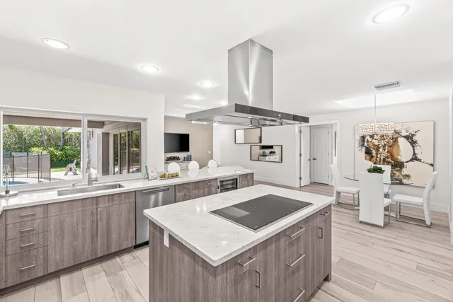 a kitchen with a stove a refrigerator and wooden cabinets