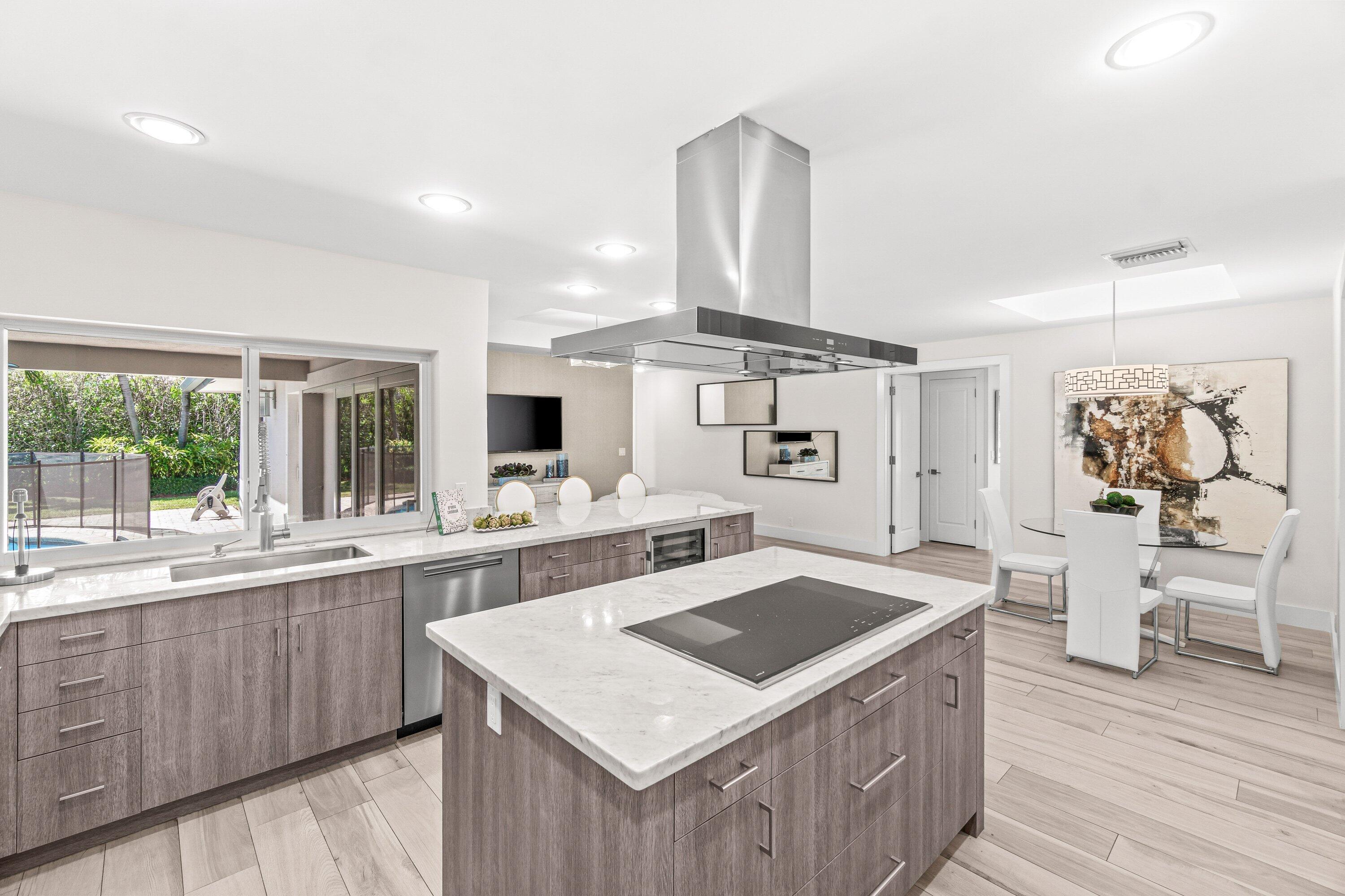2367 Queen Palm Road Boca Raton, FL 33432 - Photo 13 of 45 a kitchen with a stove a refrigerator and wooden cabinets