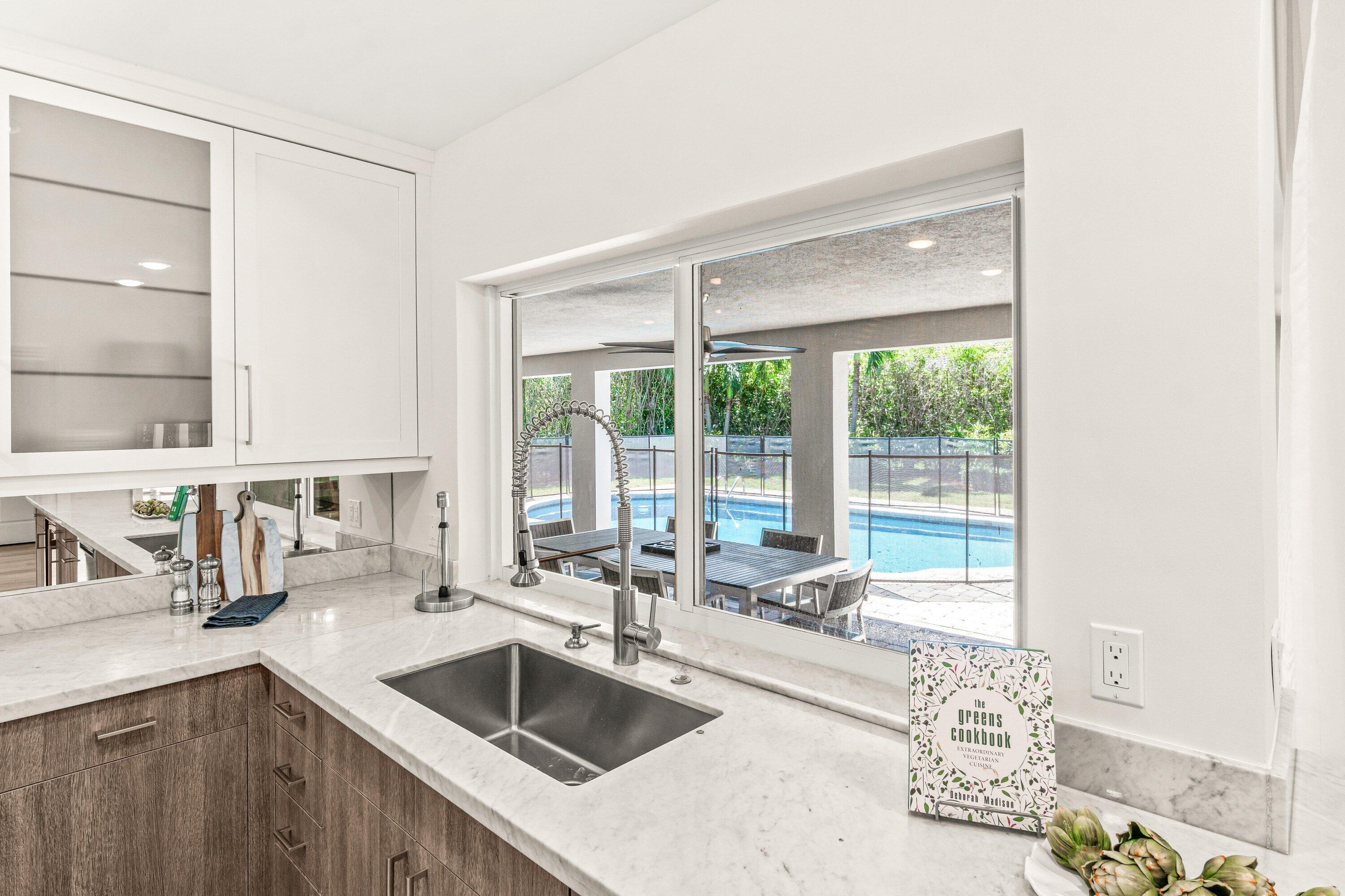 2367 Queen Palm Road Boca Raton, FL 33432 - Photo 14 of 45 a kitchen with a sink and a large window