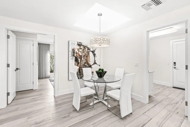 a view of a dining room with furniture wooden floor and a chandelier