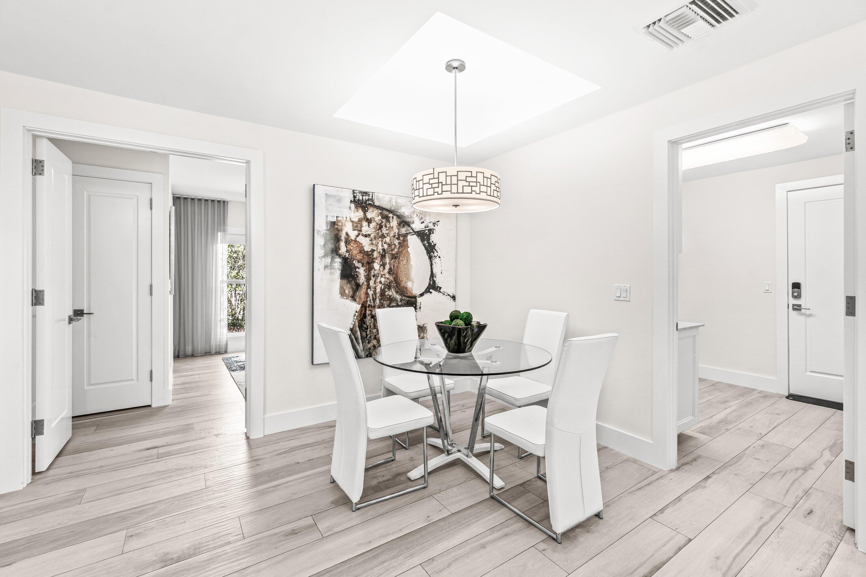 2367 Queen Palm Road Boca Raton, FL 33432 - Photo 15 of 45 a view of a dining room with furniture wooden floor and a chandelier