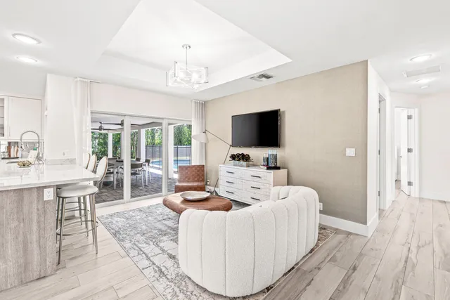 a living room with furniture a flat screen tv and a fireplace