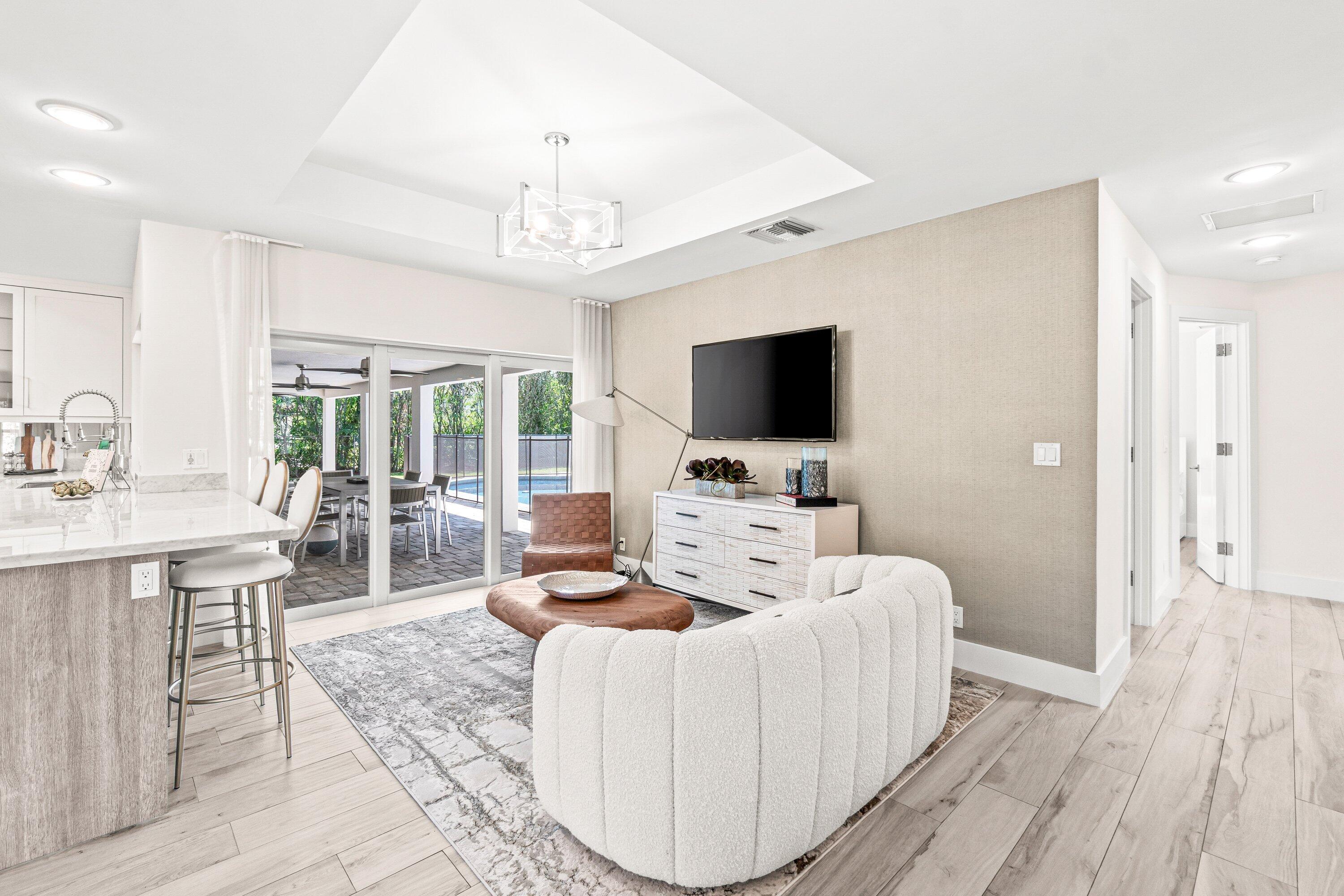 2367 Queen Palm Road Boca Raton, FL 33432 - Photo 17 of 45 a living room with furniture a flat screen tv and a fireplace