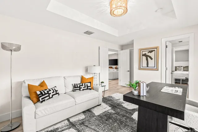 a living room with furniture and wooden floor