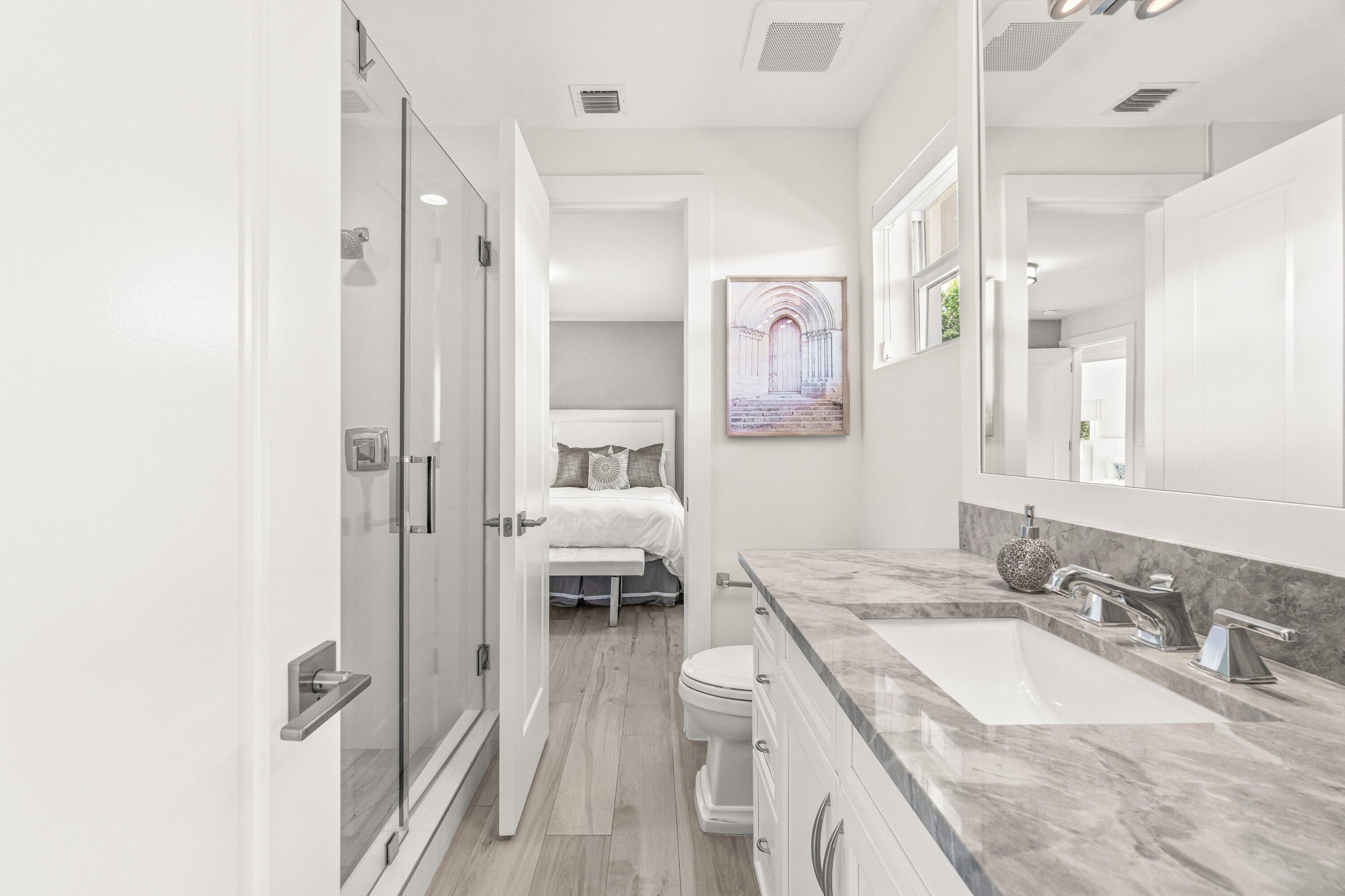 2367 Queen Palm Road Boca Raton, FL 33432 - Photo 21 of 45 a en suite bathroom with a granite countertop double vanity sink a mirror and a shower