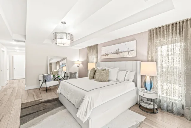 a large bedroom with a bed and a chandelier