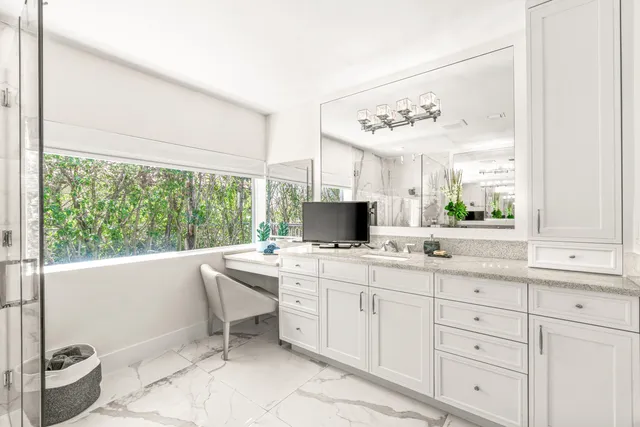 a kitchen with a sink and large window