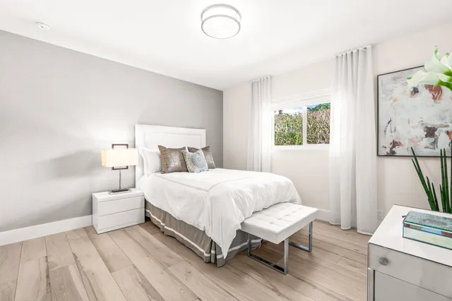 a bedroom with a bed and a window