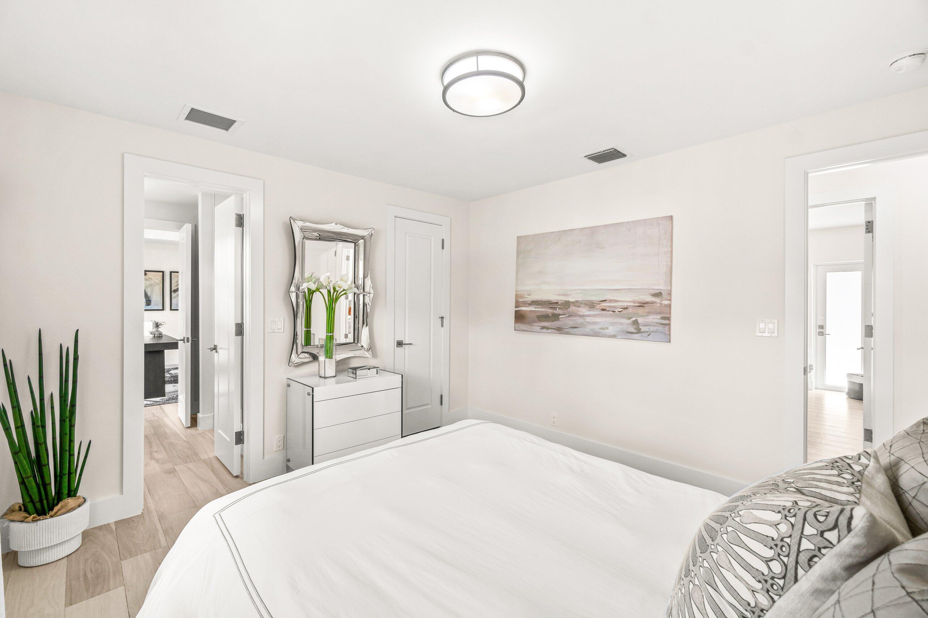 2367 Queen Palm Road Boca Raton, FL 33432 - Photo 29 of 45 a bedroom with a large bed and a chandelier