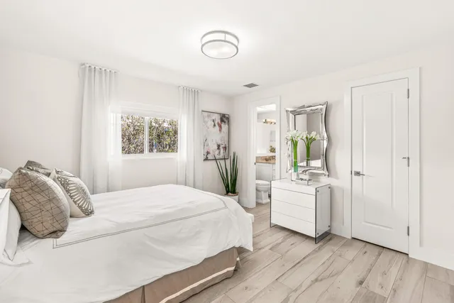 a bedroom with a large bed and a window