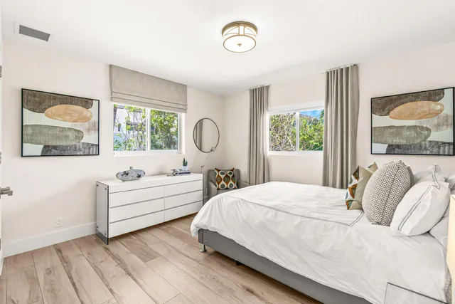 a bedroom with a large bed and a window