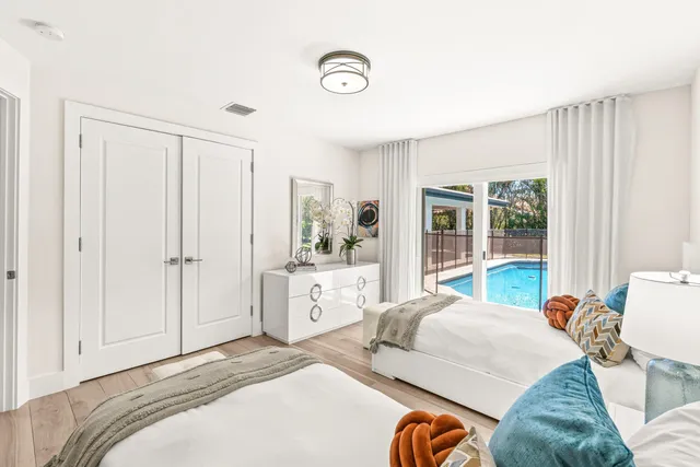 a bedroom with a bed and a large window