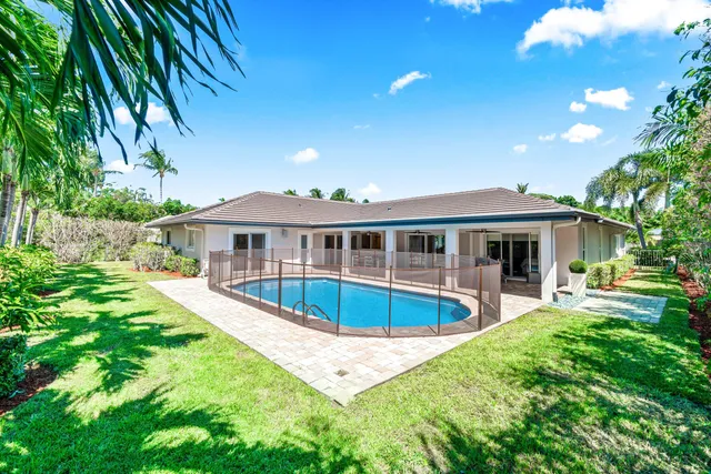 a view of a house with a yard and sitting area