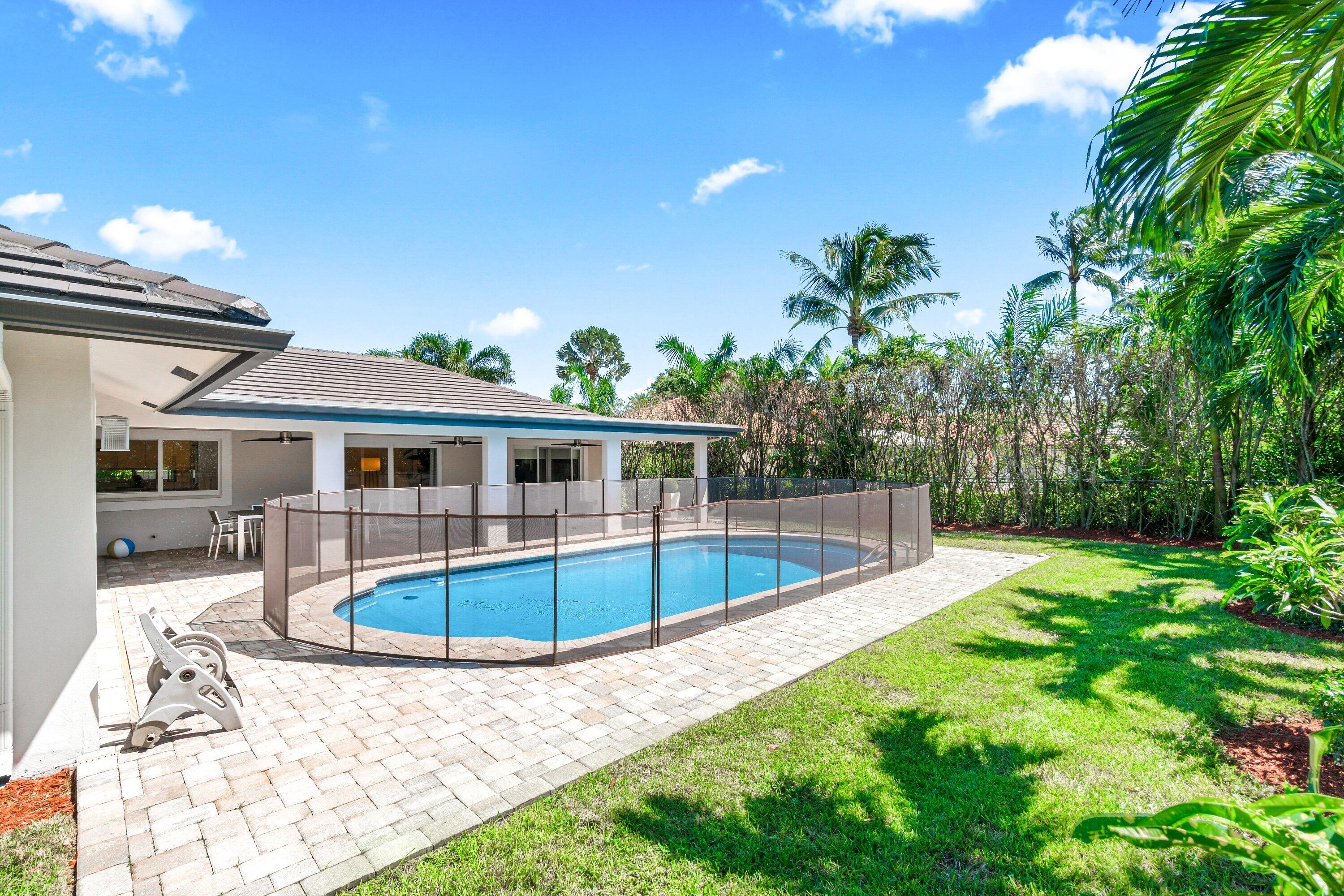 2367 Queen Palm Road Boca Raton, FL 33432 - Photo 43 of 45 a view of a house with pool fire pit a yard and swimming pool