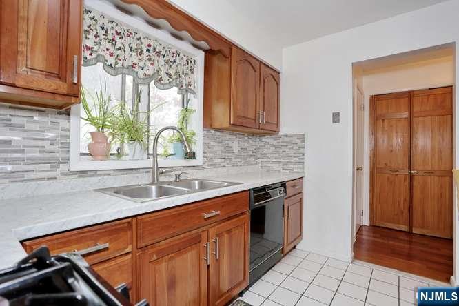 290 Hamilton Place, Unit 4 Hackensack, NJ 07601 - Photo 15 of 50 a kitchen with stainless steel appliances granite countertop a sink stove and cabinets